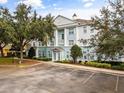 Building exterior with parking and landscaping at 7703 Heritage Crossing Way # 302, Reunion, FL 34747