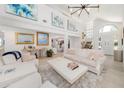Spacious living room with high ceilings, neutral decor, art, and views to the foyer at 11036 Schooner Way, Windermere, FL 34786