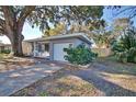 Gray exterior home with a screened porch and attached garage at 1246 Margina Ave, Daytona Beach, FL 32114