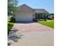 Attractive single-story house with a paved driveway and landscaped front yard at 1517 Lancashire Way, Deland, FL 32720