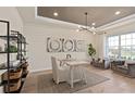 Bright home office with wood floors, built-in shelving, and a desk at 15359 Rising View Dr, Montverde, FL 34756