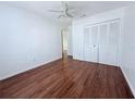 Bedroom with wood flooring, ceiling fan, and double door closet at 1627 Eagle Creek Cir # 36, Orlando, FL 32807