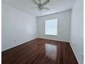 Bright bedroom with wood-look flooring and window blinds at 1627 Eagle Creek Cir # 36, Orlando, FL 32807
