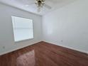 Bright bedroom with wood-look flooring and ceiling fan at 1627 Eagle Creek Cir # 36, Orlando, FL 32807