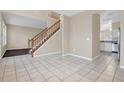 Tile floor dining area with access to kitchen and staircase at 16946 Woodcrest Way, Clermont, FL 34714