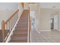 Wooden staircase with simple railing in a light-toned home at 16946 Woodcrest Way, Clermont, FL 34714