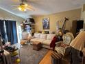 Living room with beige couch and patterned arm chair at 2864 Copper Ridge Ct, Lake Mary, FL 32746