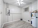 Laundry room with vinyl flooring, water heater, and electrical panel at 2911 Dudley Dr, Bartow, FL 33830
