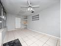 Bright sunroom with tile flooring, ceiling fan, and window bench at 2911 Dudley Dr, Bartow, FL 33830