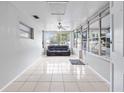Sunroom features tile floors, a ceiling fan, and ample natural light at 2911 Dudley Dr, Bartow, FL 33830