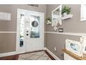 Bright entryway with hardwood floors, white door, and decorative wall accents at 355 Carriage Way Ct, Oviedo, FL 32765