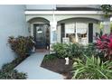 Home entrance with a charming porch, landscaping, and a walkway at 355 Carriage Way Ct, Oviedo, FL 32765