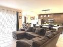 Open living room with L-shaped sectional sofa and kitchen views at 3653 Yarian Dr, Haines City, FL 33844