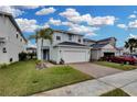 Two-story house with white garage door, and a landscaped front yard at 3657 Voyager Ln, Sanford, FL 32773