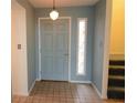 Light blue entry door with tiled floor and stained glass at 497 Oak Haven Dr, Altamonte Springs, FL 32701