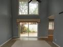 Spacious living room with high ceilings and sliding glass doors at 497 Oak Haven Dr, Altamonte Springs, FL 32701