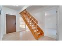 Indoor view of a wooden staircase with light-colored wood flooring at 5019 Nassau Cir # 5, Orlando, FL 32808