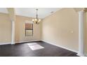 Bright dining room with dark laminate floors and chandelier at 533 Woods Landing Dr, Minneola, FL 34715