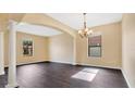Bright dining room with dark laminate floors and chandelier at 533 Woods Landing Dr, Minneola, FL 34715
