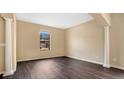 Spacious living room with dark laminate floors and columns at 533 Woods Landing Dr, Minneola, FL 34715
