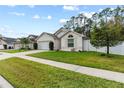 Houses on a tree-lined street, one with a white garage door at 562 Eagle Pointe S, Kissimmee, FL 34746