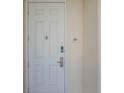 White front door with keyless entry and address number 202 at 7501 Mourning Dove Cir # 202, Reunion, FL 34747