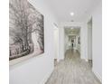 Bright and spacious hallway with tile floors and large wall art, leading to other rooms at 7901 Dausset St, Orlando, FL 32827