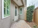 Side entry with brick walkway, landscaping, and a wooden fence at 111 Bayou Bend Rd, Groveland, FL 34736