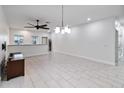 Bright dining room with tile floors and modern chandelier at 13444 Stoddart Ave, Orlando, FL 32827