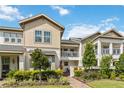Charming townhouse with well-maintained landscaping, a brick path and metal balcony at 13444 Stoddart Ave, Orlando, FL 32827