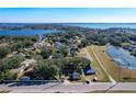 Aerial view of a home on a lake with lush green landscape at 1968 Berkley Rd, Auburndale, FL 33823