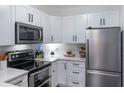 Modern white kitchen with stainless steel appliances at 206 E South St # 6031, Orlando, FL 32801