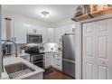 Modern white kitchen with stainless steel appliances at 206 E South St # 6031, Orlando, FL 32801