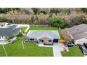 Aerial view of a renovated home with gray exterior and a spacious backyard at 272 Iowa Woods W Cir, Orlando, FL 32824
