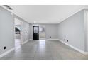 Bright and airy living room with tile floors and an open floor plan at 272 Iowa Woods W Cir, Orlando, FL 32824