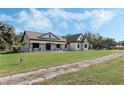 House with stone and stucco exterior, a covered porch, and a long driveway at 2850 Horton Rd, Kissimmee, FL 34744