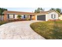 Brick ranch house with attached garage and landscaped lawn at 2855 Cady Way, Winter Park, FL 32792