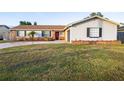 One-story home with gray siding, landscaping, and a curved driveway at 2855 Cady Way, Winter Park, FL 32792