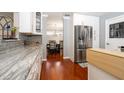 Modern kitchen with stainless steel appliances, granite counters, and white cabinets at 2855 Cady Way, Winter Park, FL 32792