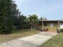 Green ranch house with a long driveway and mature landscaping at 3109 Surfside Way, Orlando, FL 32805