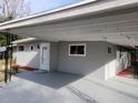 House exterior featuring carport and gray painted walls at 32650 Azealia Pl, Tavares, FL 32778