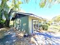 View of the backyard featuring a well-maintained lawn, mature trees, and a patio area ideal for outdoor entertaining at 3421 Fudge Rd, Apopka, FL 32712