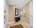 Light and airy entryway with tile floors and bench at 3799 S Atlantic Ave # 602, Daytona Beach, FL 32118