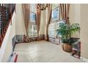 Bright dining room with large windows and chandelier at 3915 Shoreview Dr, Kissimmee, FL 34744