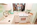 White kitchen with modern appliances and ocean view at 4153 S Atlantic Ave # 1020, New Smyrna Beach, FL 32169