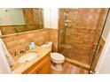 Clean bathroom with tiled shower and granite vanity at 4153 S Atlantic Ave # 1030, New Smyrna Beach, FL 32169