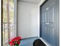 Apartment entrance with dark door, unit number, and covered porch adorned with flowers at 4208 Clubside Dr # 4208, Longwood, FL 32779
