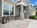 Inviting front porch with stone flooring and a bench at 421 Nowell Loop, Deland, FL 32724