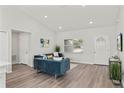 Bright living room with teal sofas, wood-look floors, and ample natural light at 4386 Sw 169Th Lane Rd, Ocala, FL 34473
