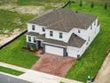 An aerial view of the home, showcasing the backyard and the home's roofline and landscaping at 5067 Northern Dove Ave, Mount Dora, FL 32757